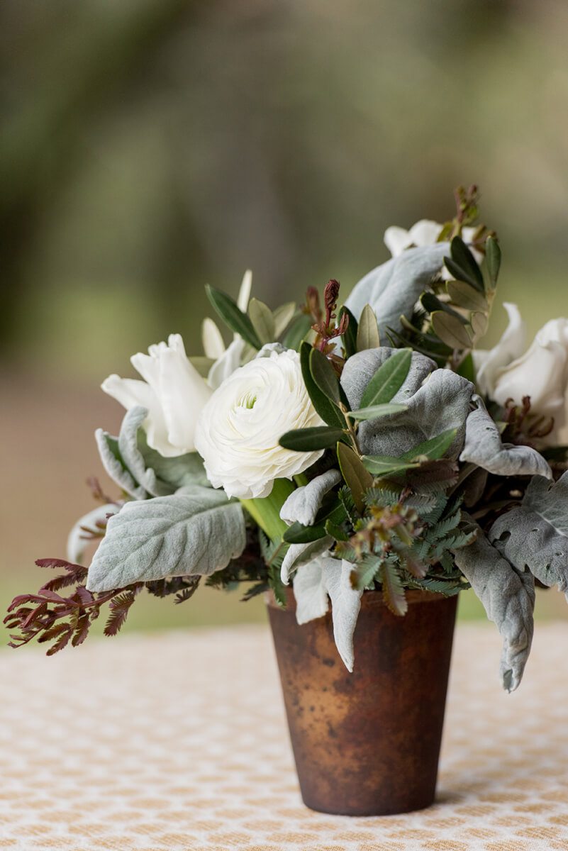 Rustic white flower centerpiece on white tablecloth