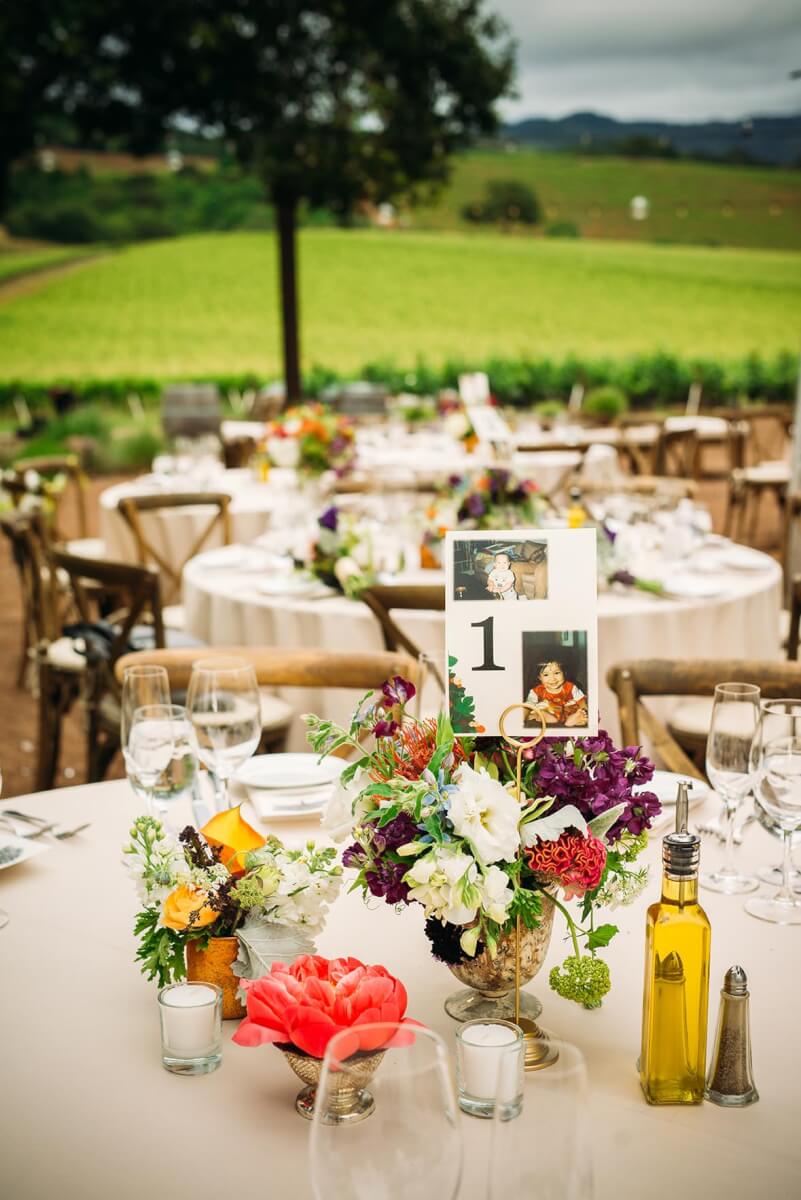 Small floral wedding arrangements on outdoor table with Sonoma county hills in background