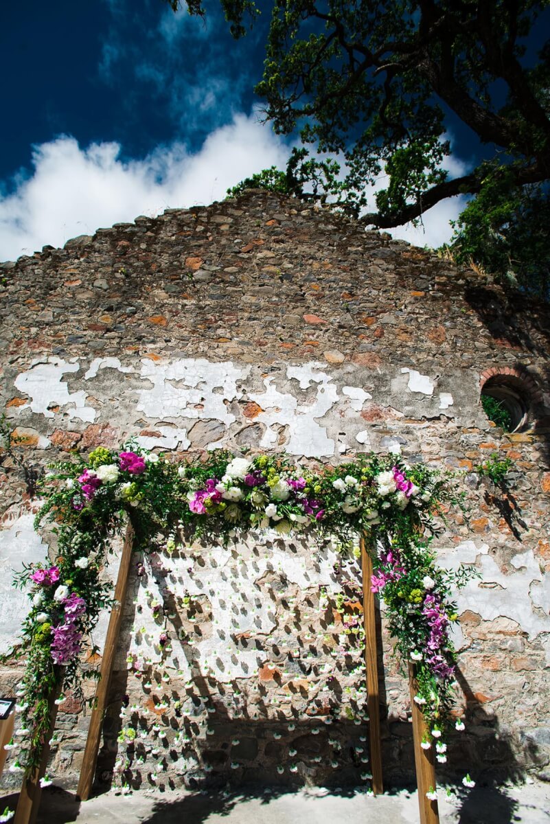 Wedding arch flowers set up in front of rustic Sonoma county brick building