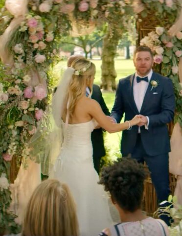 bride and groom surrounded by elegant florals by Aimee Lomeli Designs in a Geico commercial