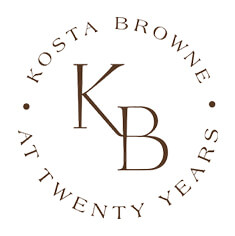 Square image with white background with 'KB,' 'KOSTA BROWNE' and 'AT TWENTY YEARS' written in dark font