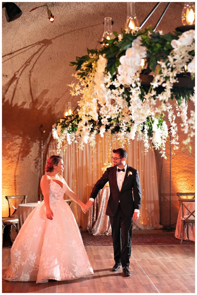 Romantic floral chandelier above bride and groom on dance floor at Calistoga Ranch Wedding, Wine Country Wedding Florist