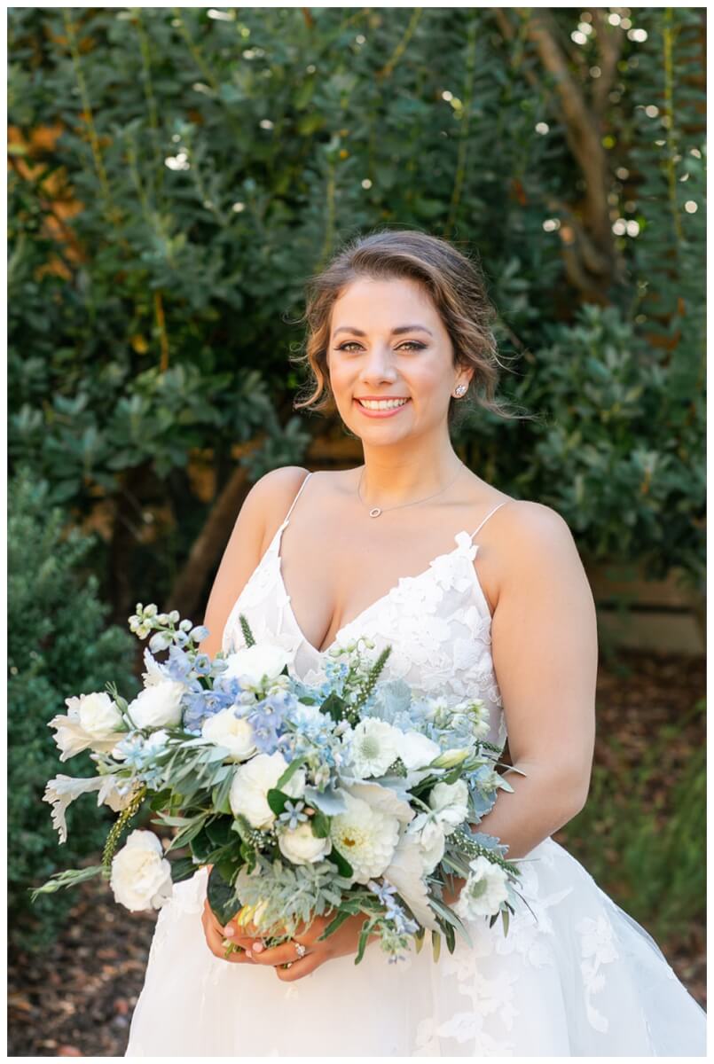 Bride holding organic soft blue and cream bridal bouquet by Aimee Lomeli Designs, Calistoga Ranch Wedding Florist