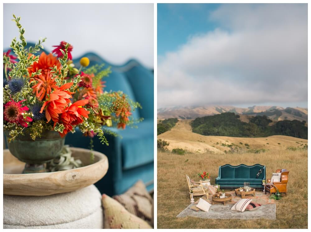 Bright, bold floral arrangement and a vintage seating area at a bohemian wedding in the hills of Sonoma County