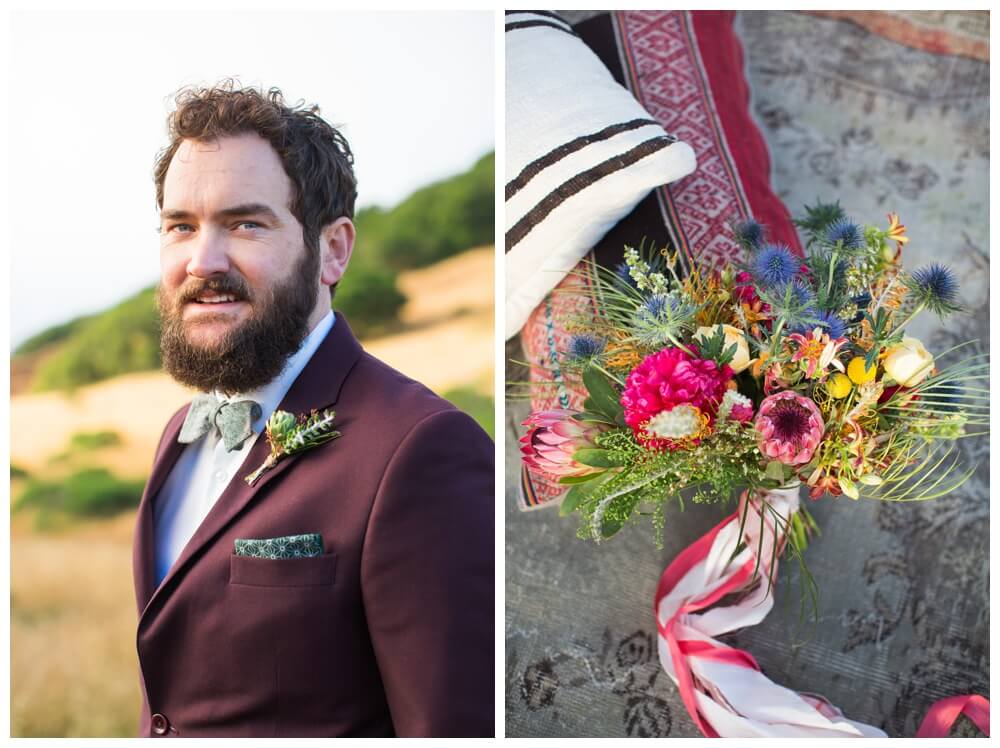 Groom in a burgundy suit jacket and brightly colored floral arrangment
