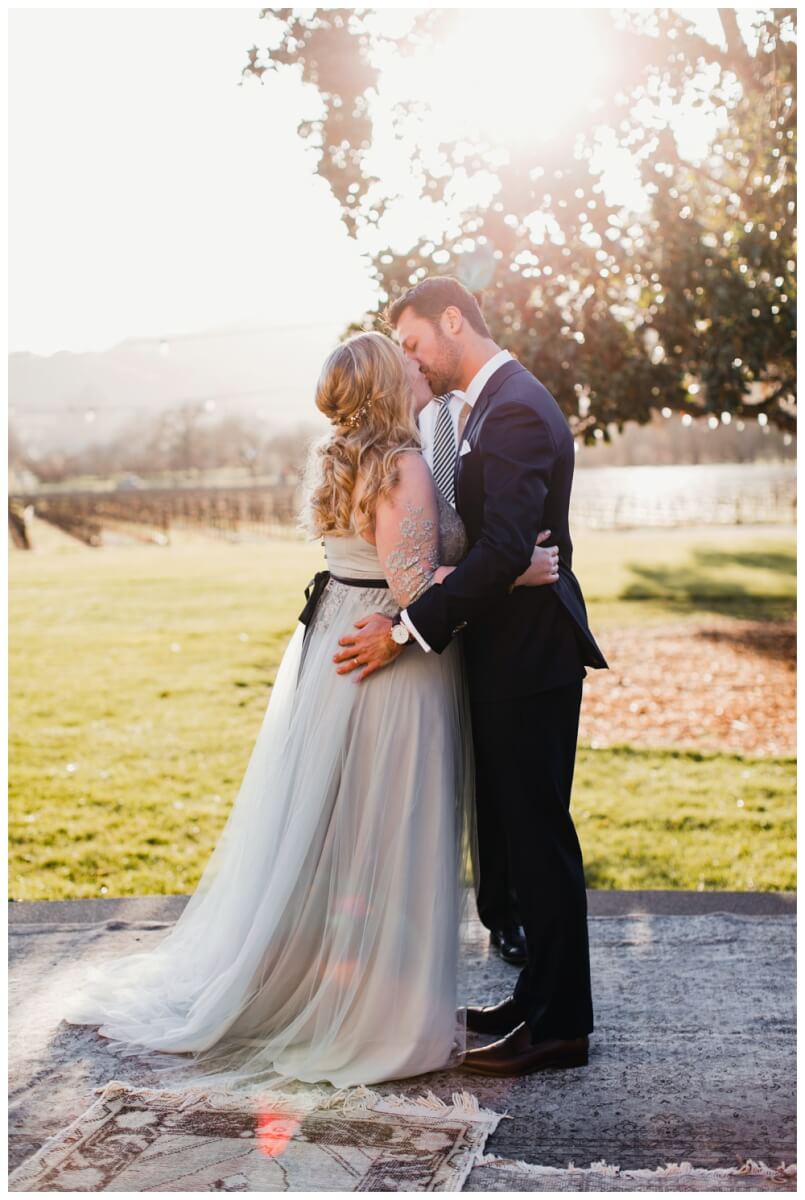 Bride and groom kissing at Chateau St. John Wedding in Napa Valley, Winery Wedding, Aimee Lomeli Designs