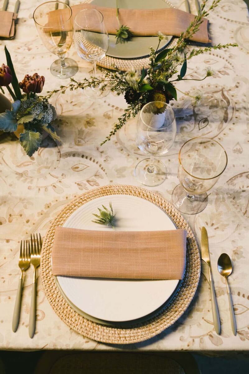 an elegant place setting with a single small floral detail