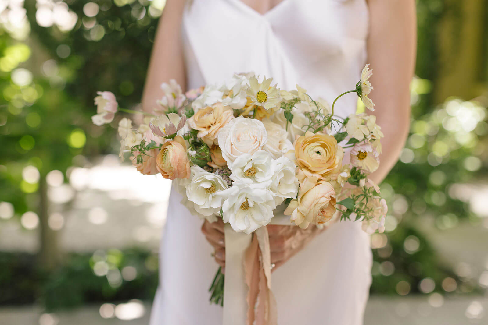 closeup of the bridal bouquet of soft peach and buttercream flowers