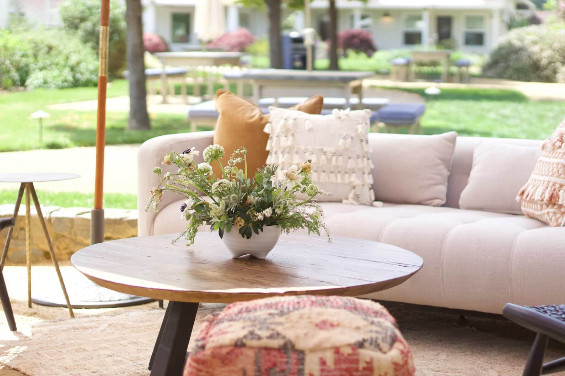 an outdoor winery event sitting area with a couch a floral arrangement on a table