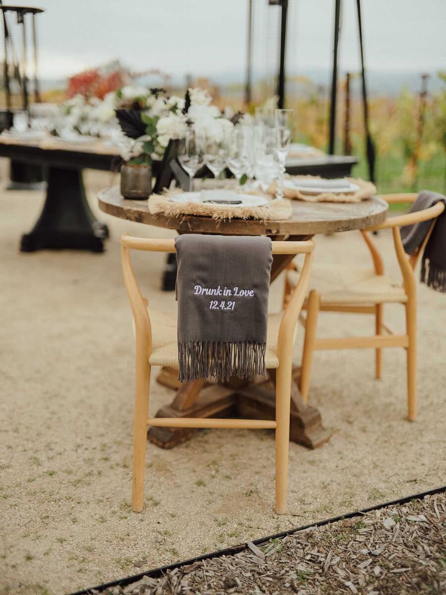 The wedding table with black and white floral arrangements in a vineyard