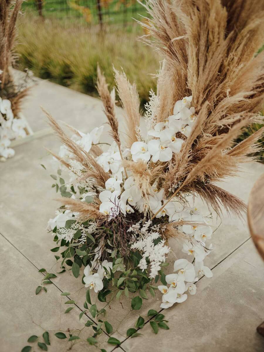 detail of the pampas grass and white flower wedding ceremony arch