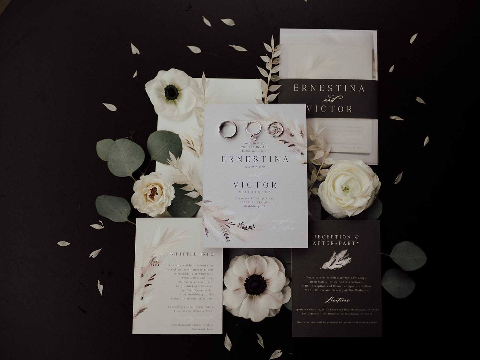 Black and white wedding invitations with flowers.